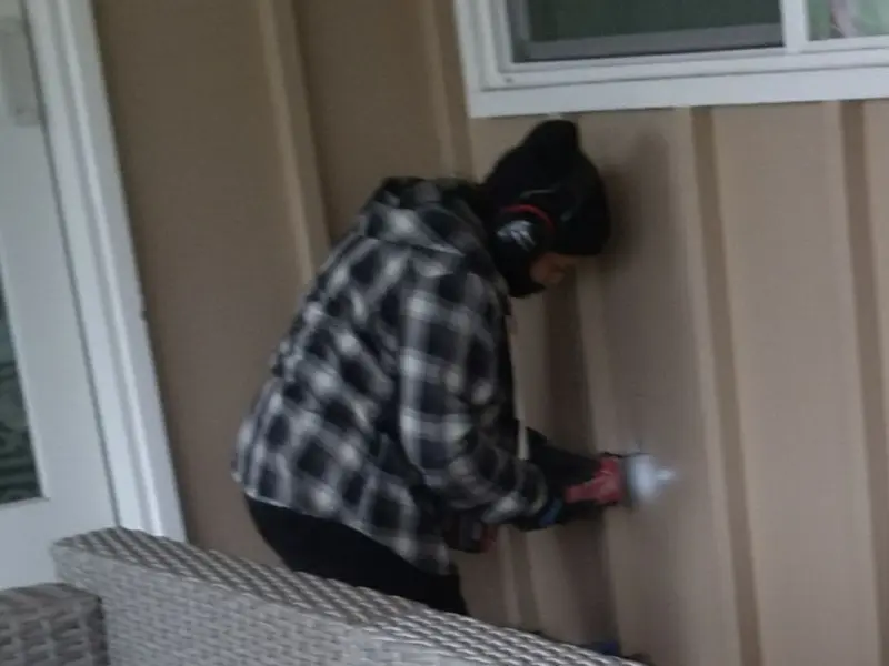 Professional electrician installing an exterior outlet in Alliance